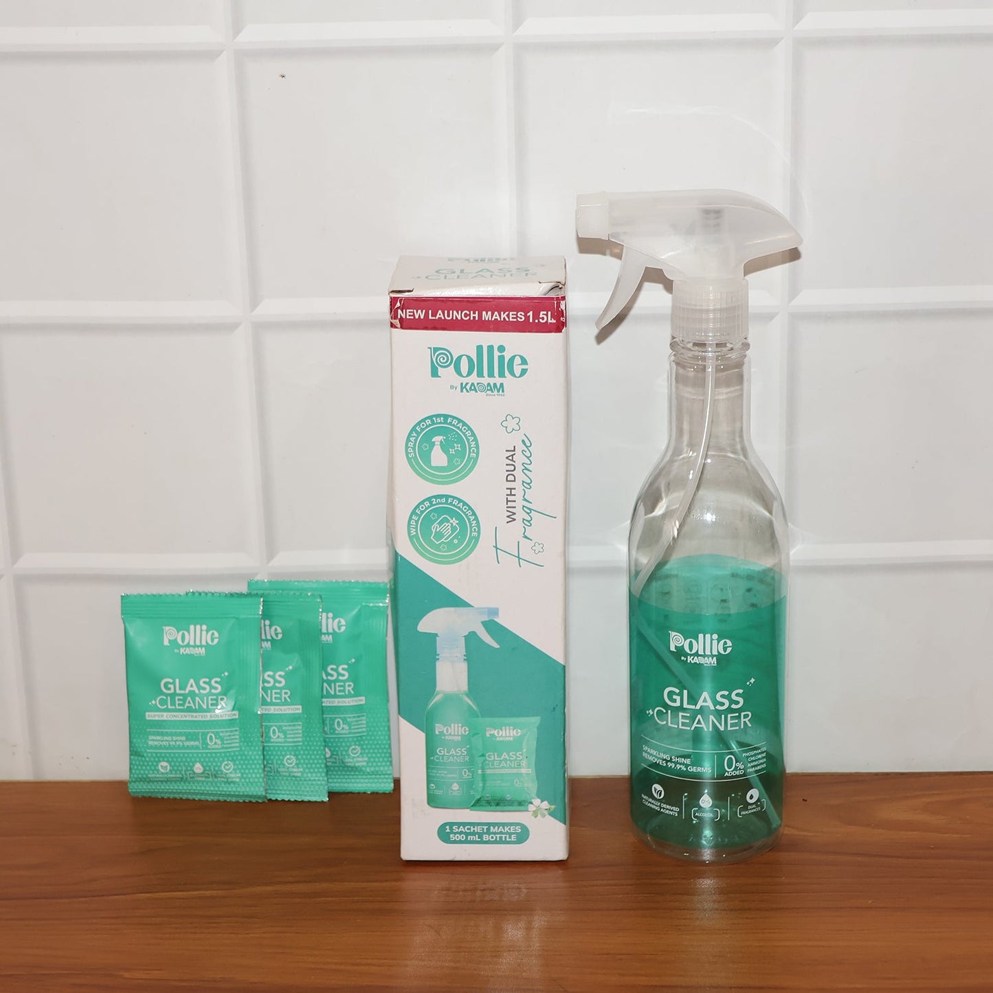 Spray bottle misting concentrated glass cleaner solution on glass surface for cleaning.