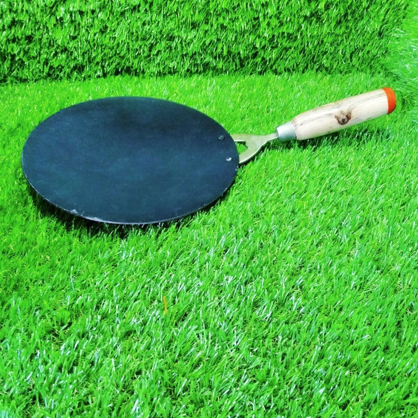 Top-down view of a round Wooden Handle Roti Tawa ready for use.
