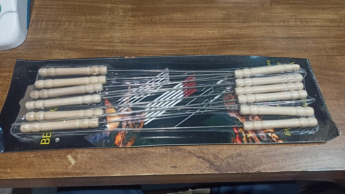 Delicious cooked meats and vegetables served on a plate using tandoor grill sticks.