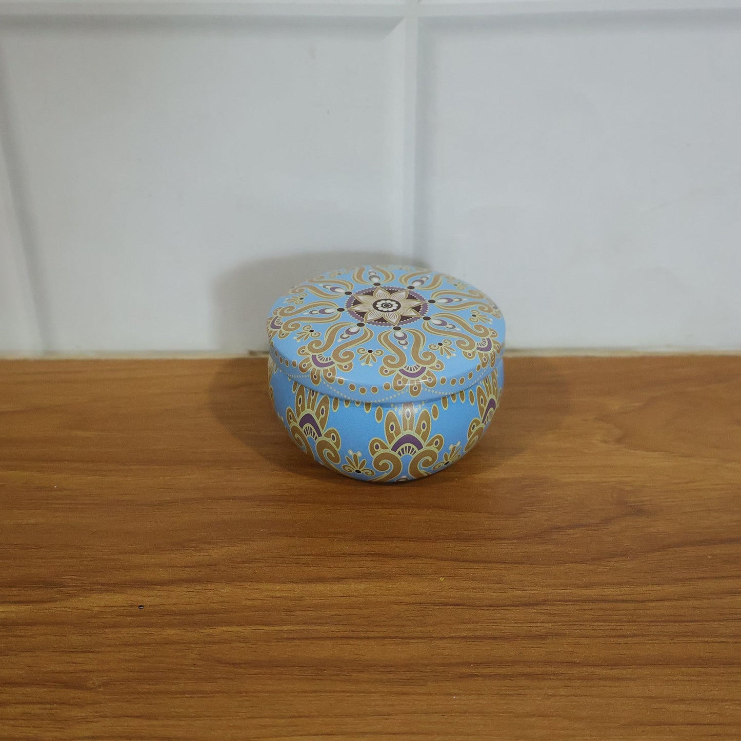 Mandala printed metal candle tin in home decor setting