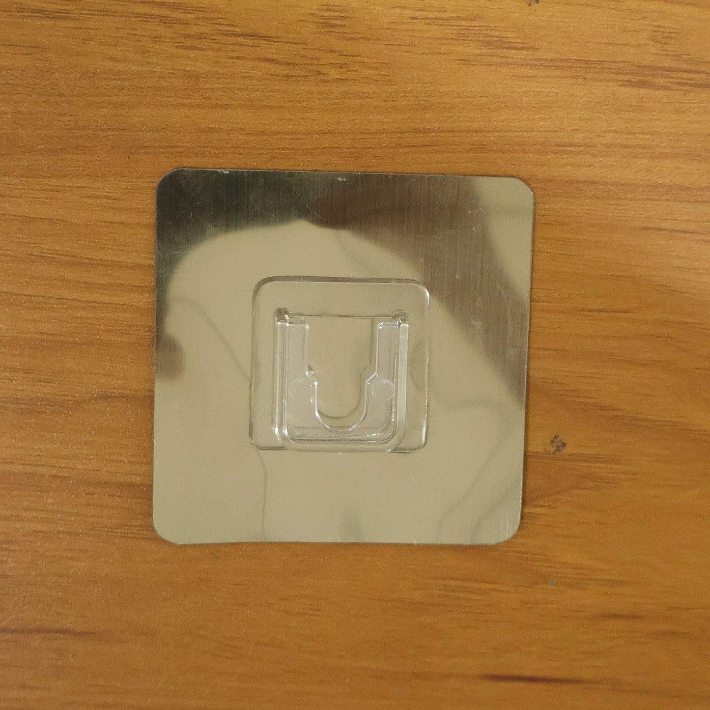 Wall mounted adhesive hook supporting hanging objects