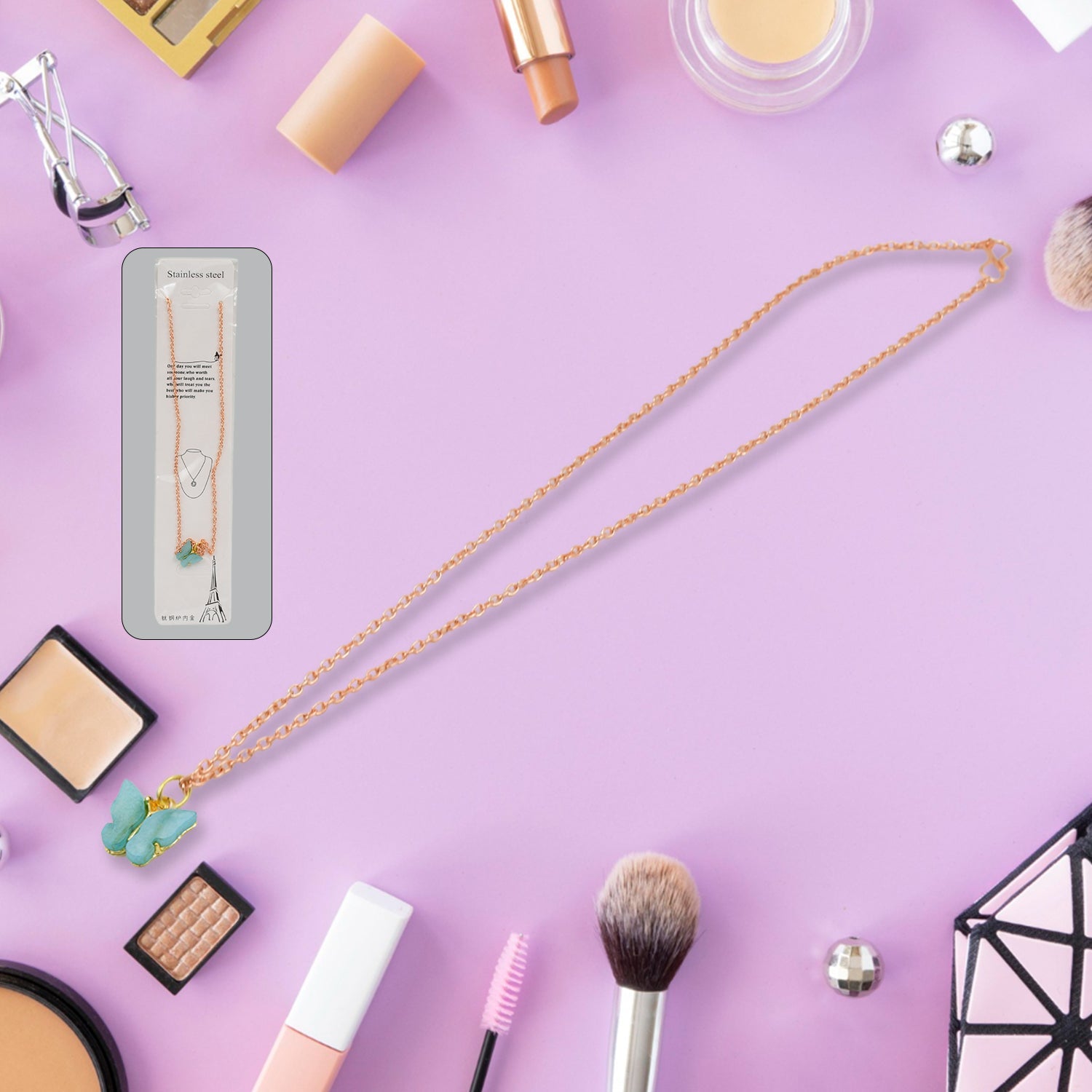 Full view of the charm chain necklace displaying multiple playful designs.