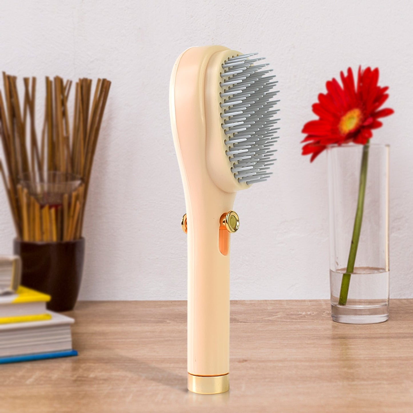 Close-up of self-cleaning button on anti-static massage hairbrush
