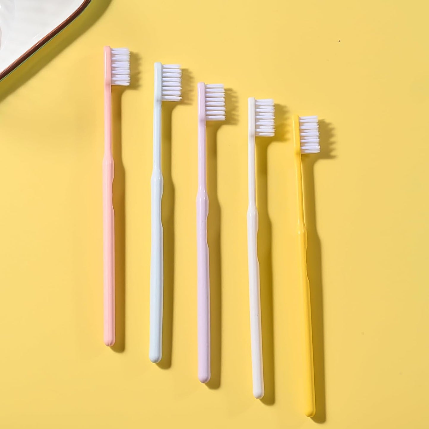 Arrangement of multicolor soft plastic toothbrushes, showcasing the variety in the family pack.