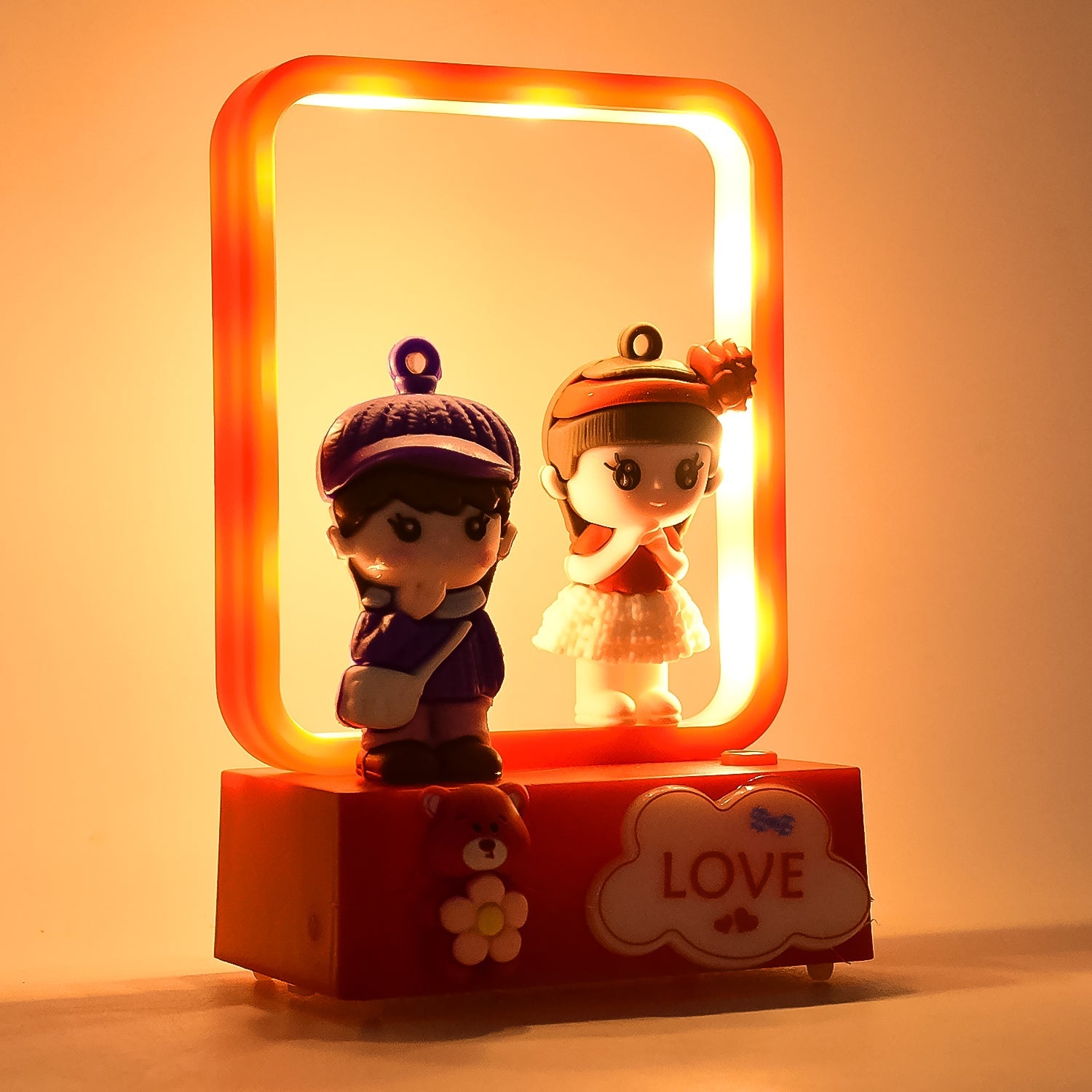 Close-up of LED decorative couple figurine light with love theme