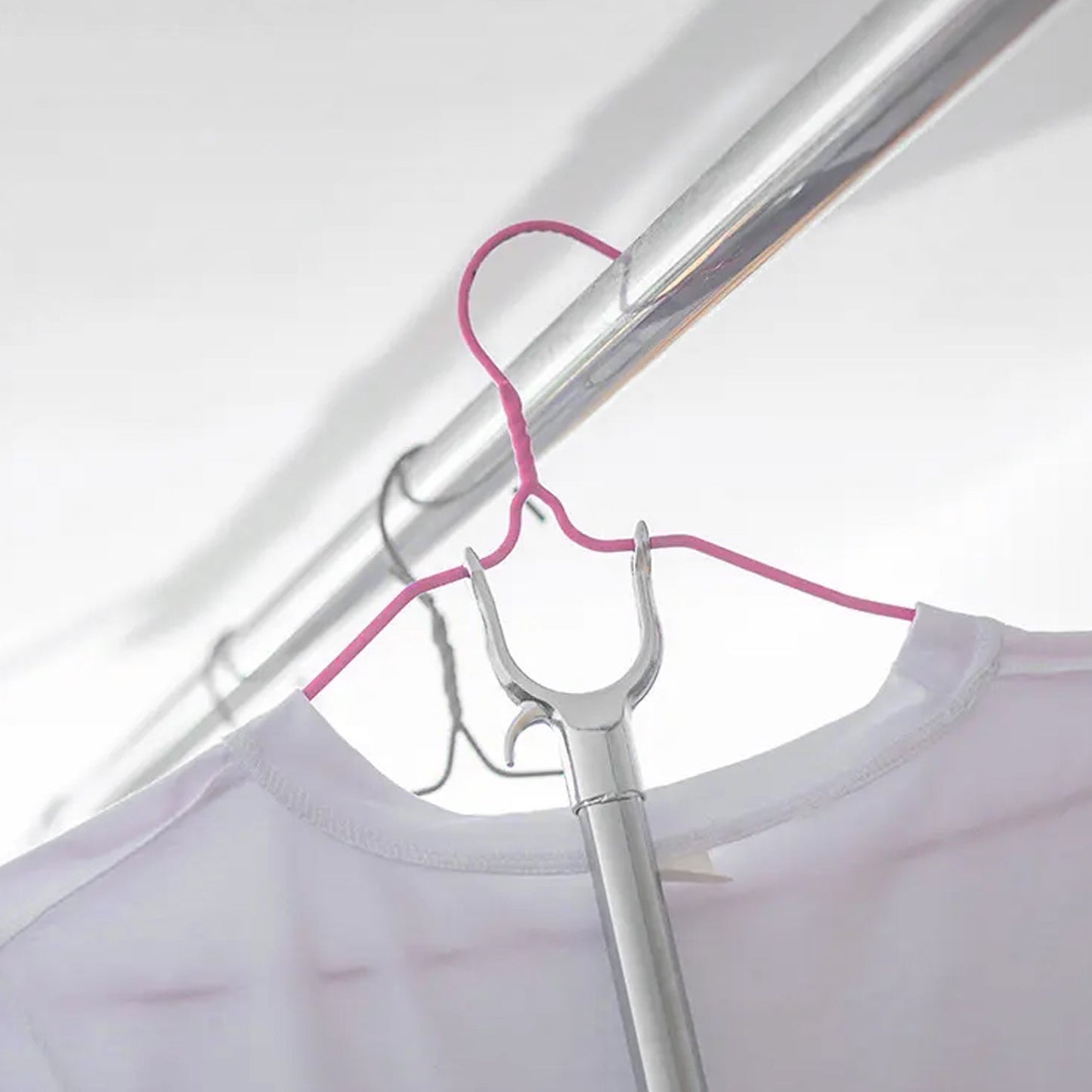 Collapsible garment hanging stick demonstrating its compact storage feature.