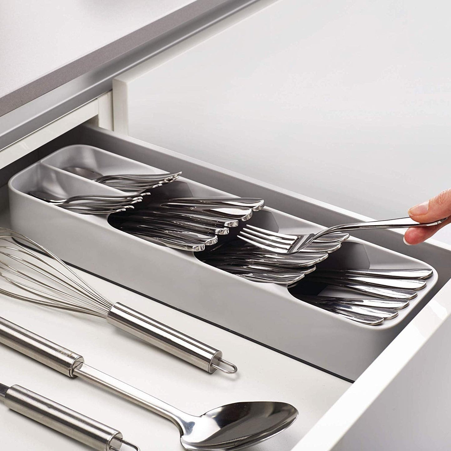 An empty, grey plastic cutlery tray with multiple compartments for kitchen drawer organisation.
