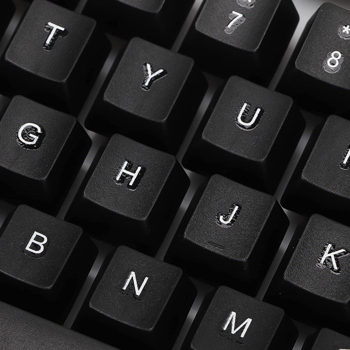 Angled view of the wired keyboard, highlighting its full-size layout and ergonomic key placement.