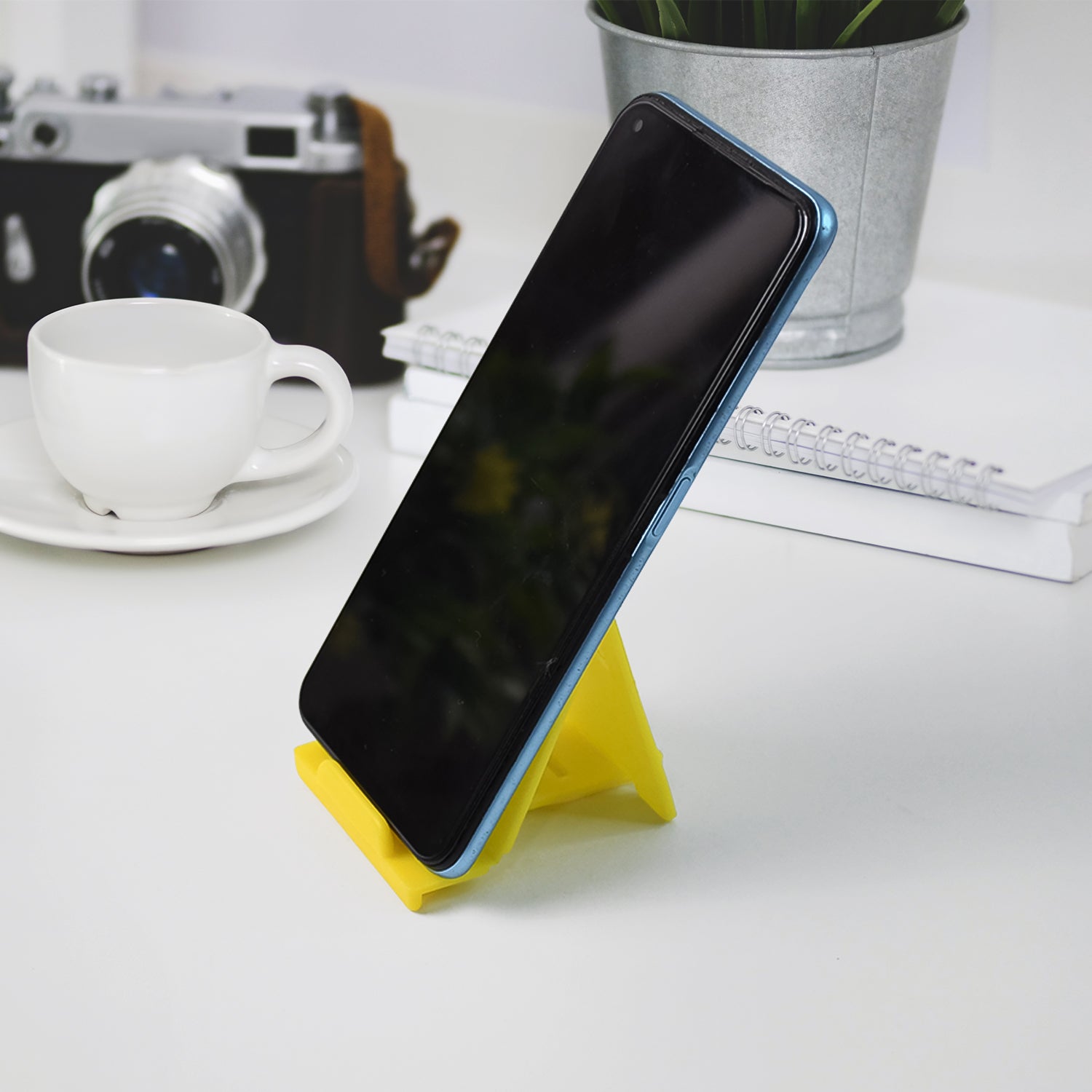 Foldable mobile phone stand placed on desk for stable support