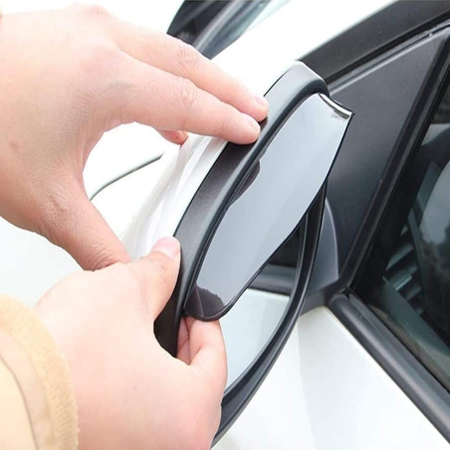 Two clear rain protectors with red adhesive strips are displayed next to a product package for rear view mirror rain