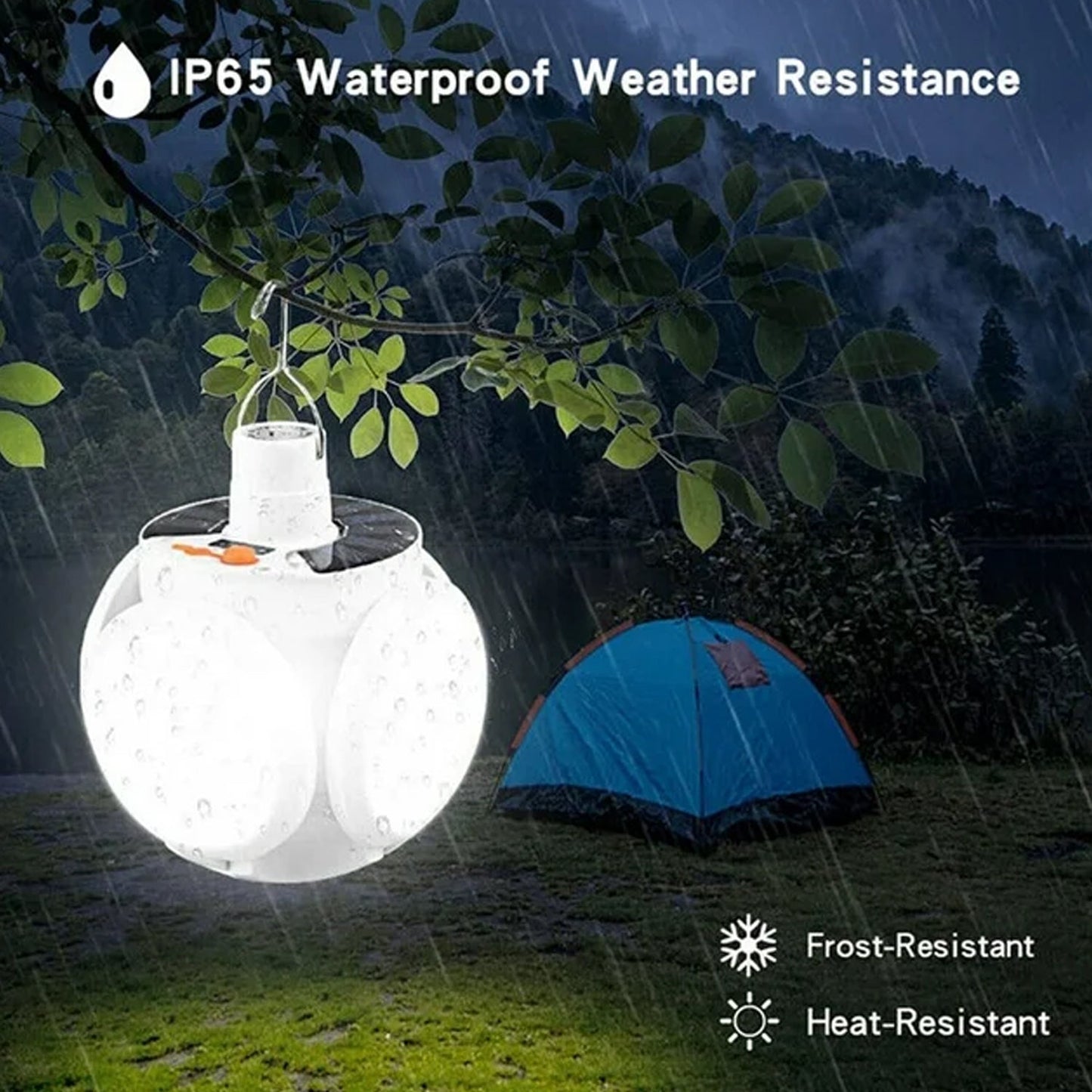 The white solar camping light hangs from a tree branch in the rain, illuminating a blue tent and demonstrating its