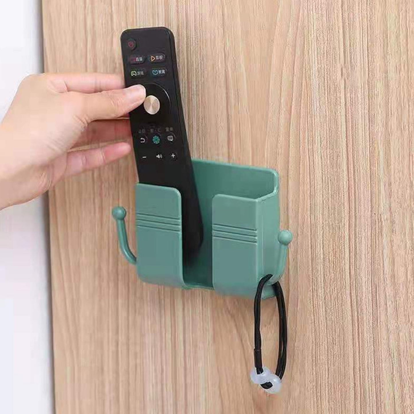 Compact wallmount mobile stand with integrated hook, holding a smartphone and keys.