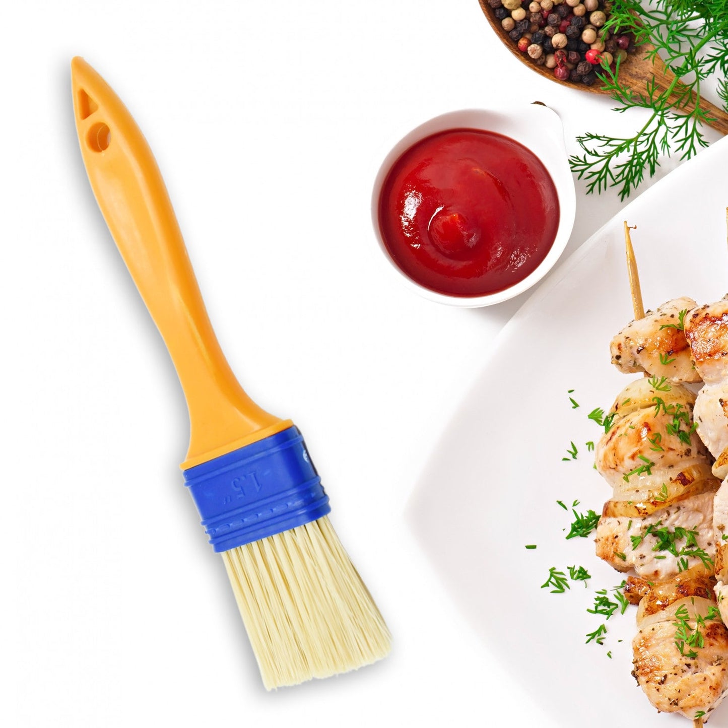 A red cooking brush evenly basting meat on a grill.
