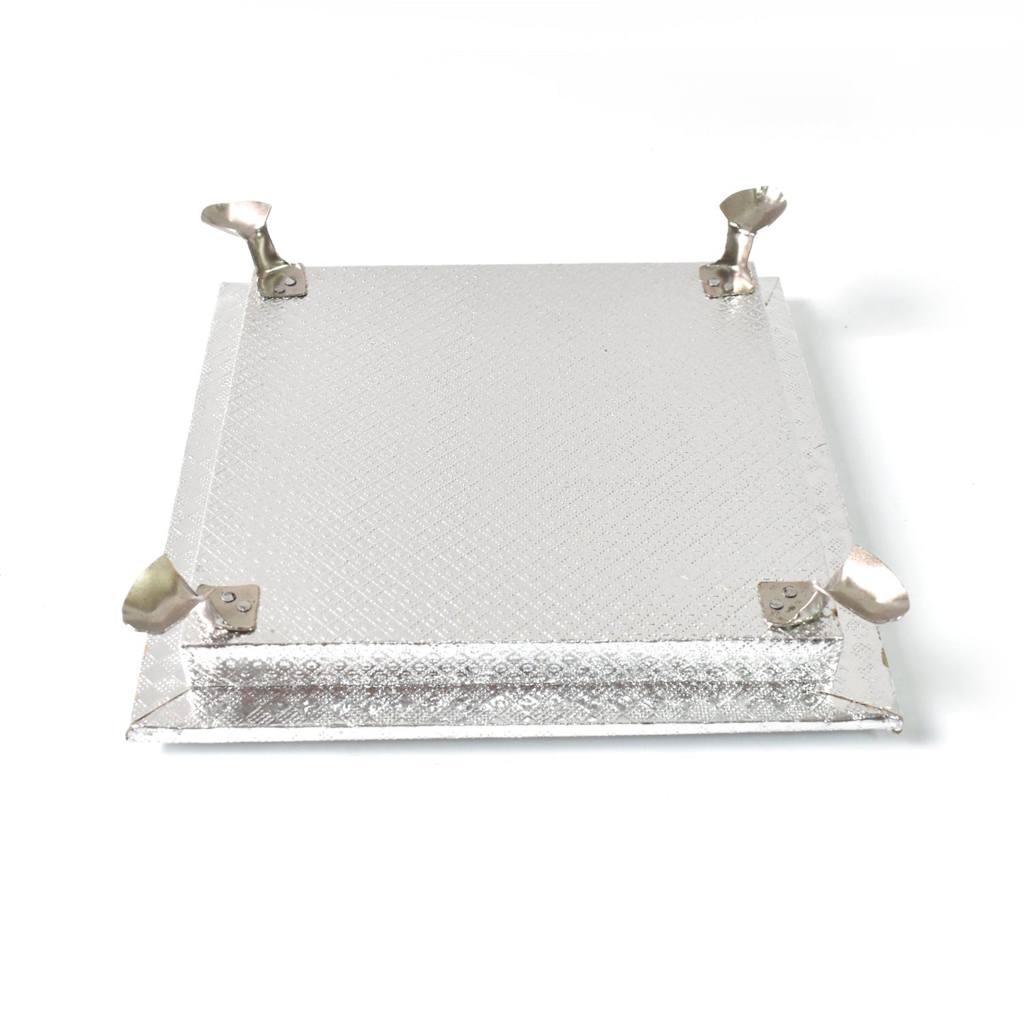 Silver pooja platform with a serene Ganesha carving, ideal for home temples and altars.