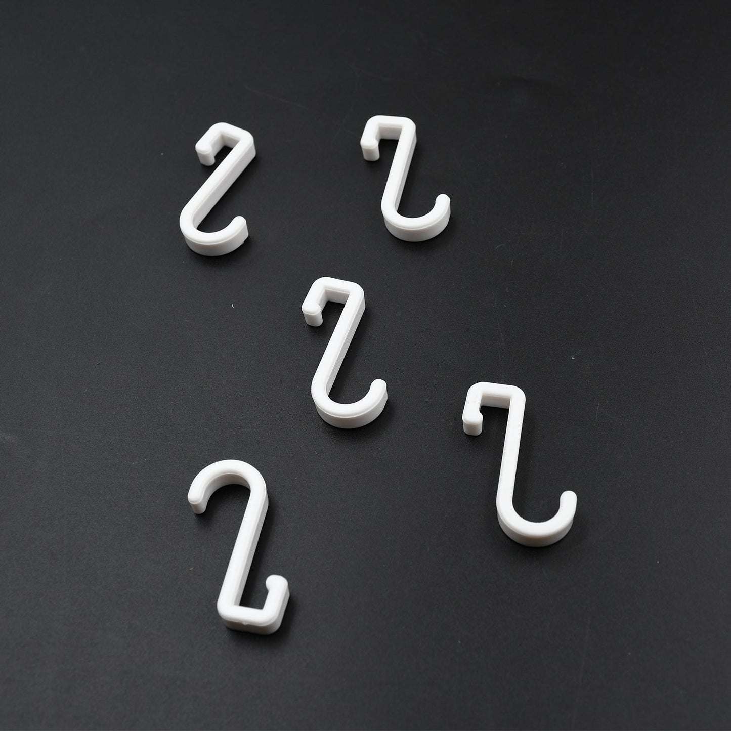 Multi-angle view of the strong self-adhesive plastic hook, highlighting its sleek design.