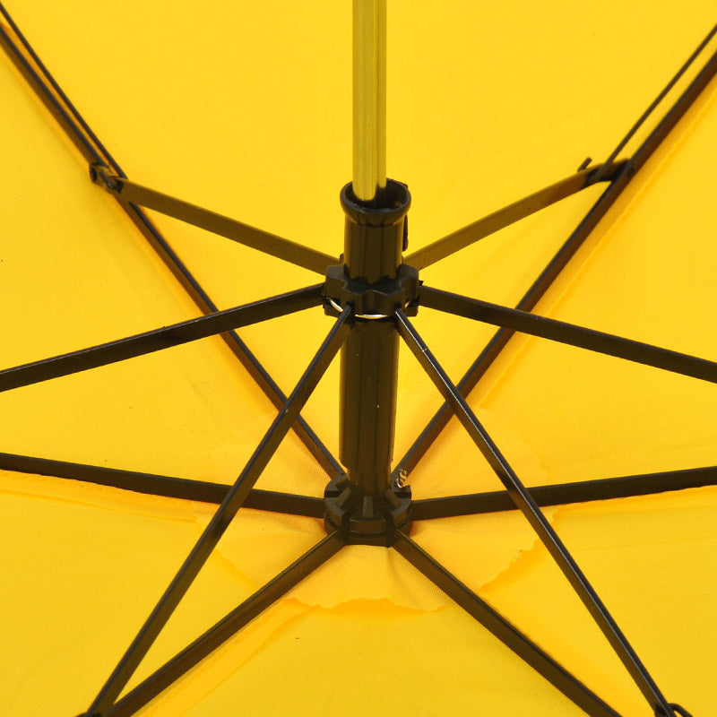 A close-up view of the black metal frame and ribs supporting the bright yellow fabric of an open umbrella.