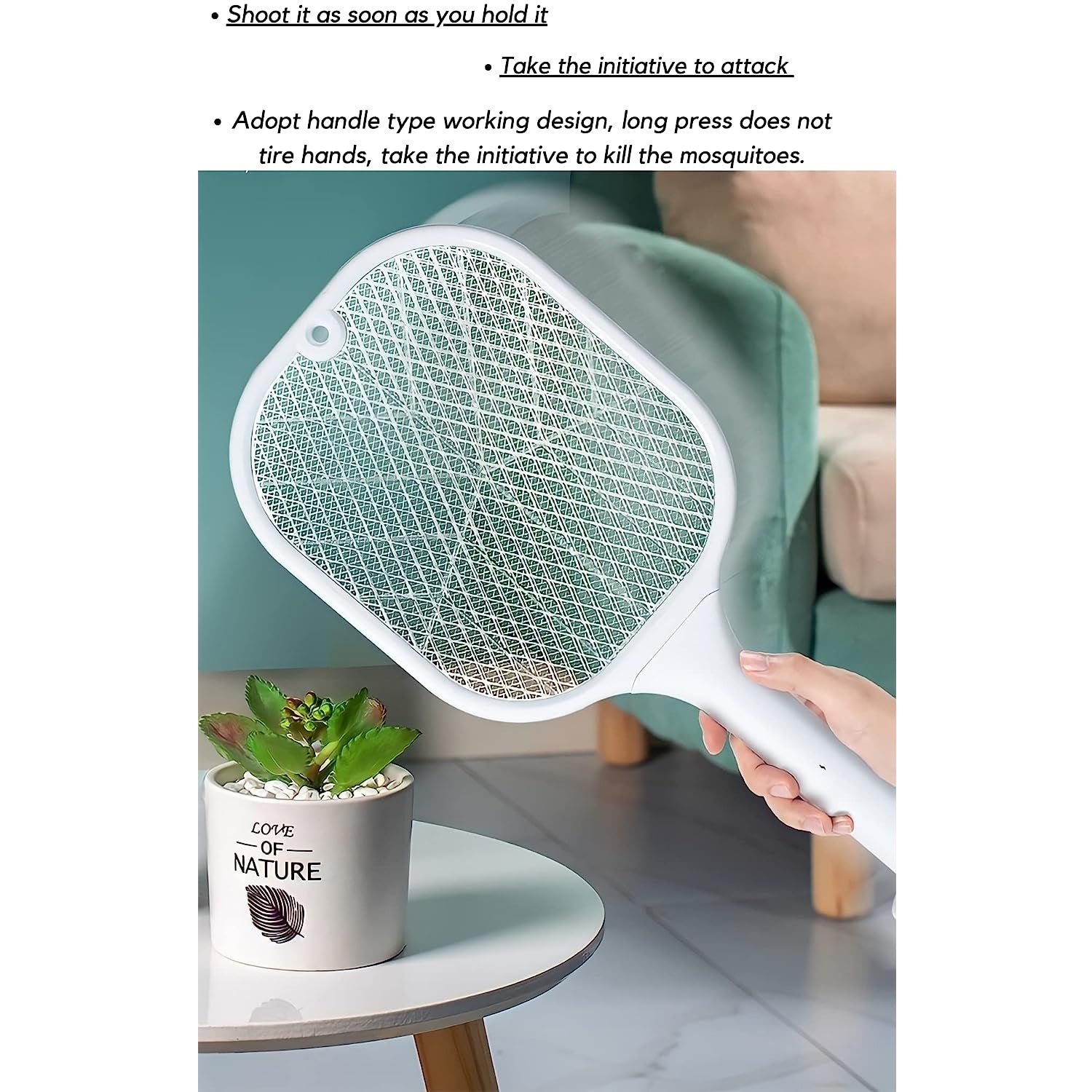 A hand holds a white mosquito killer racket over a small table with a potted succulent, near a green chair.