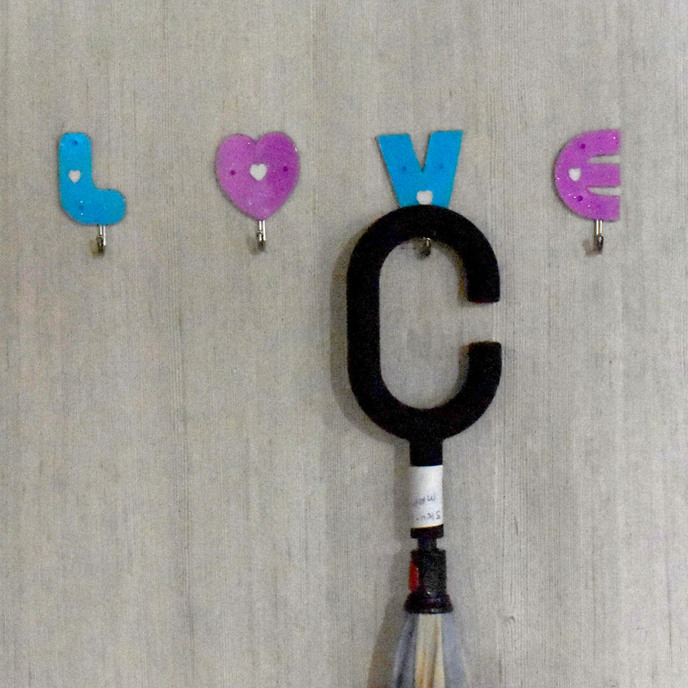 Decorative love shape self adhesive hooks enhancing room aesthetics.