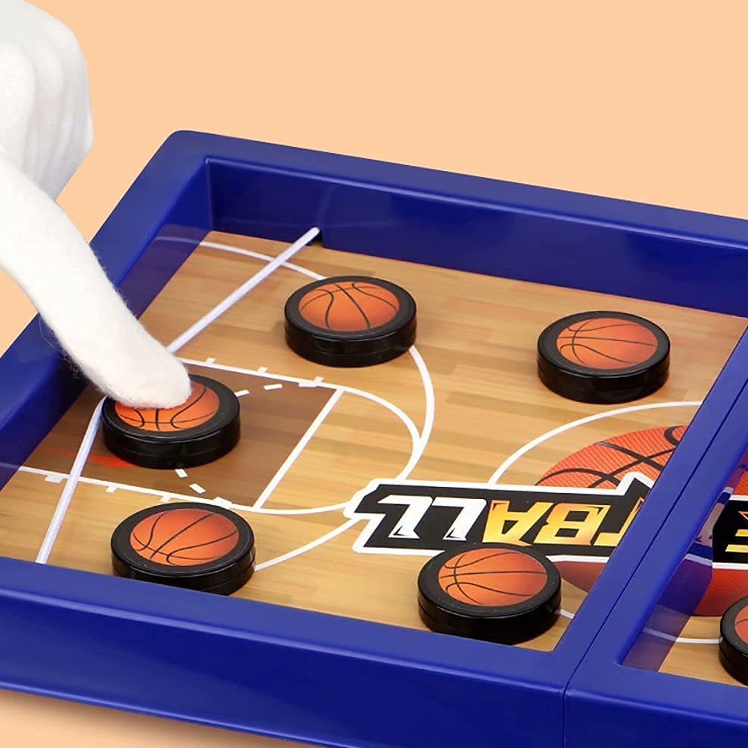 Close-up of the durable PVC game board and orange pucks for the desktop basketball game.