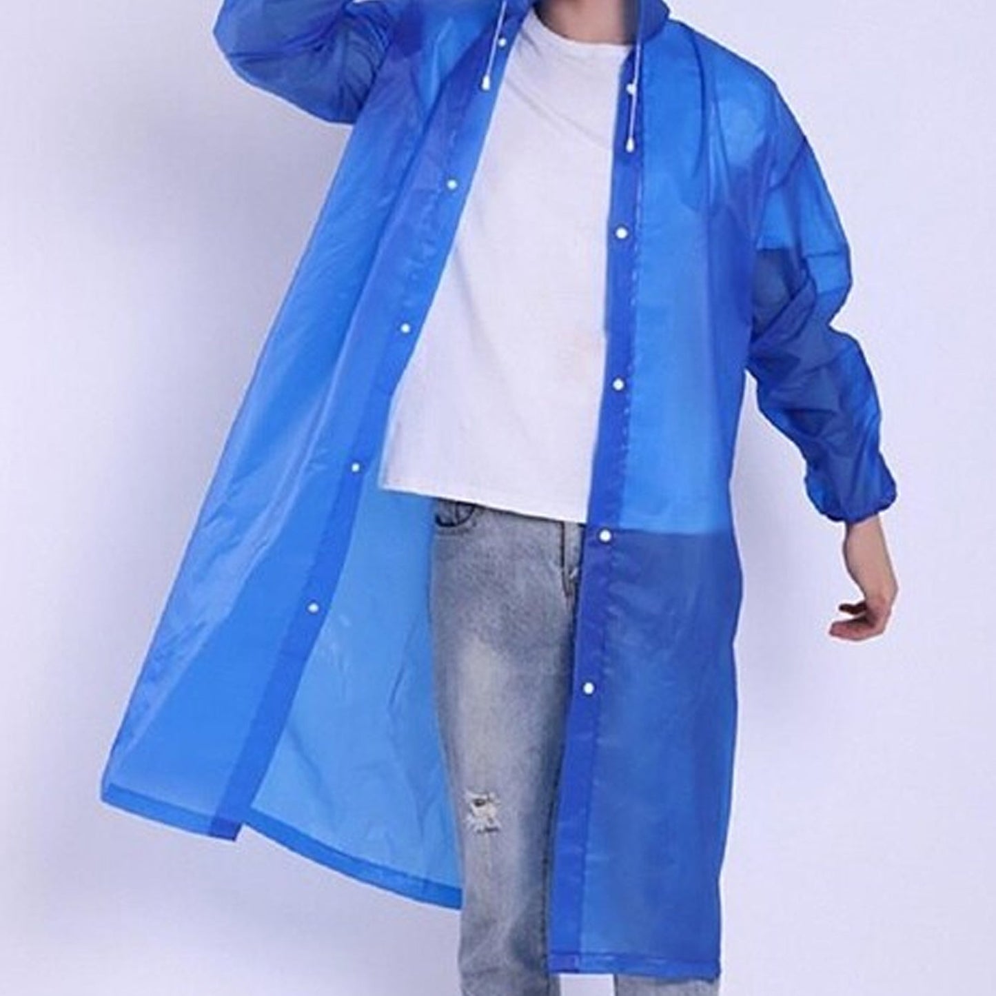 A person models a blue translucent rain jacket, unbuttoned, revealing a white t-shirt and jeans.