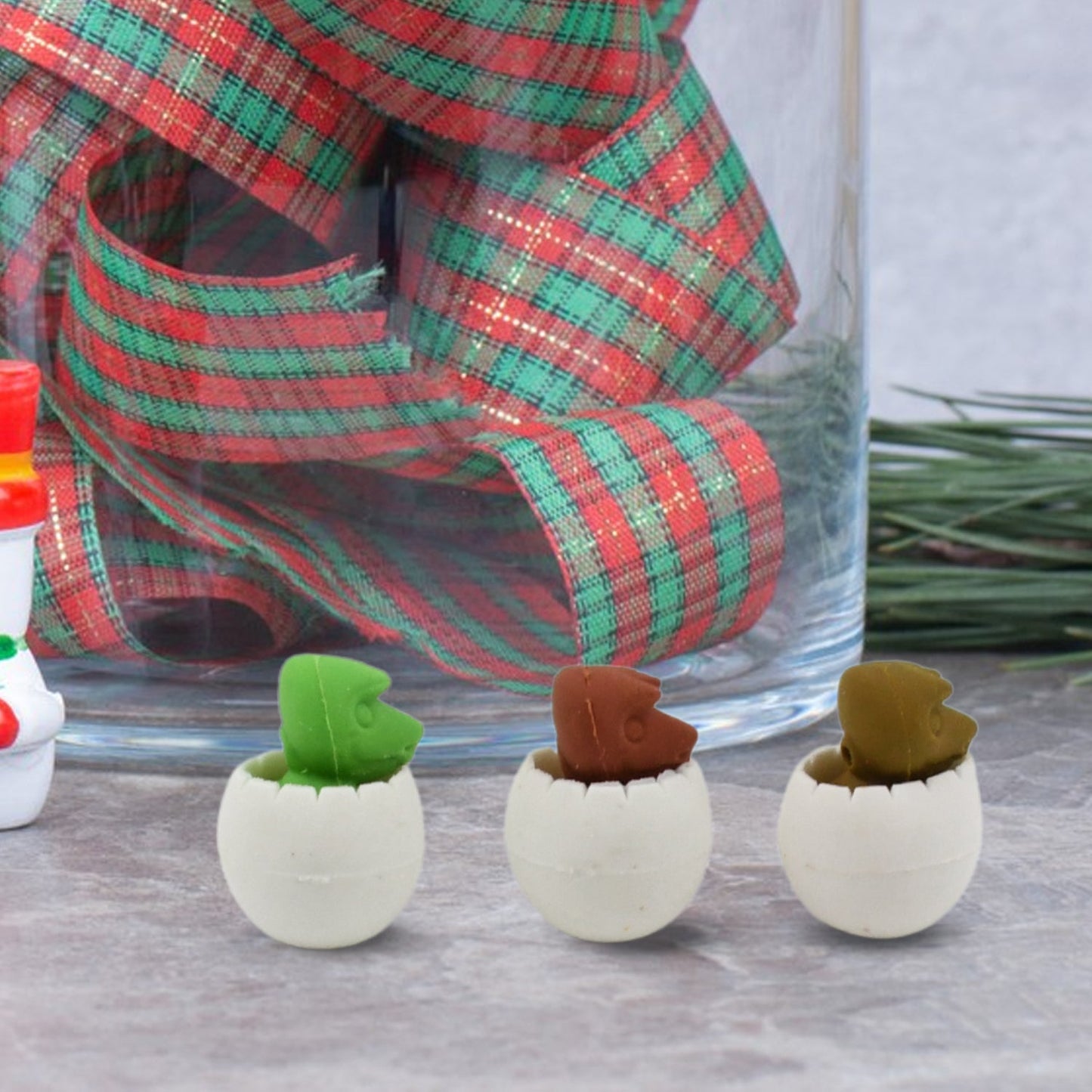 Various colorful dinosaur puzzle erasers arranged on a clean white background.
