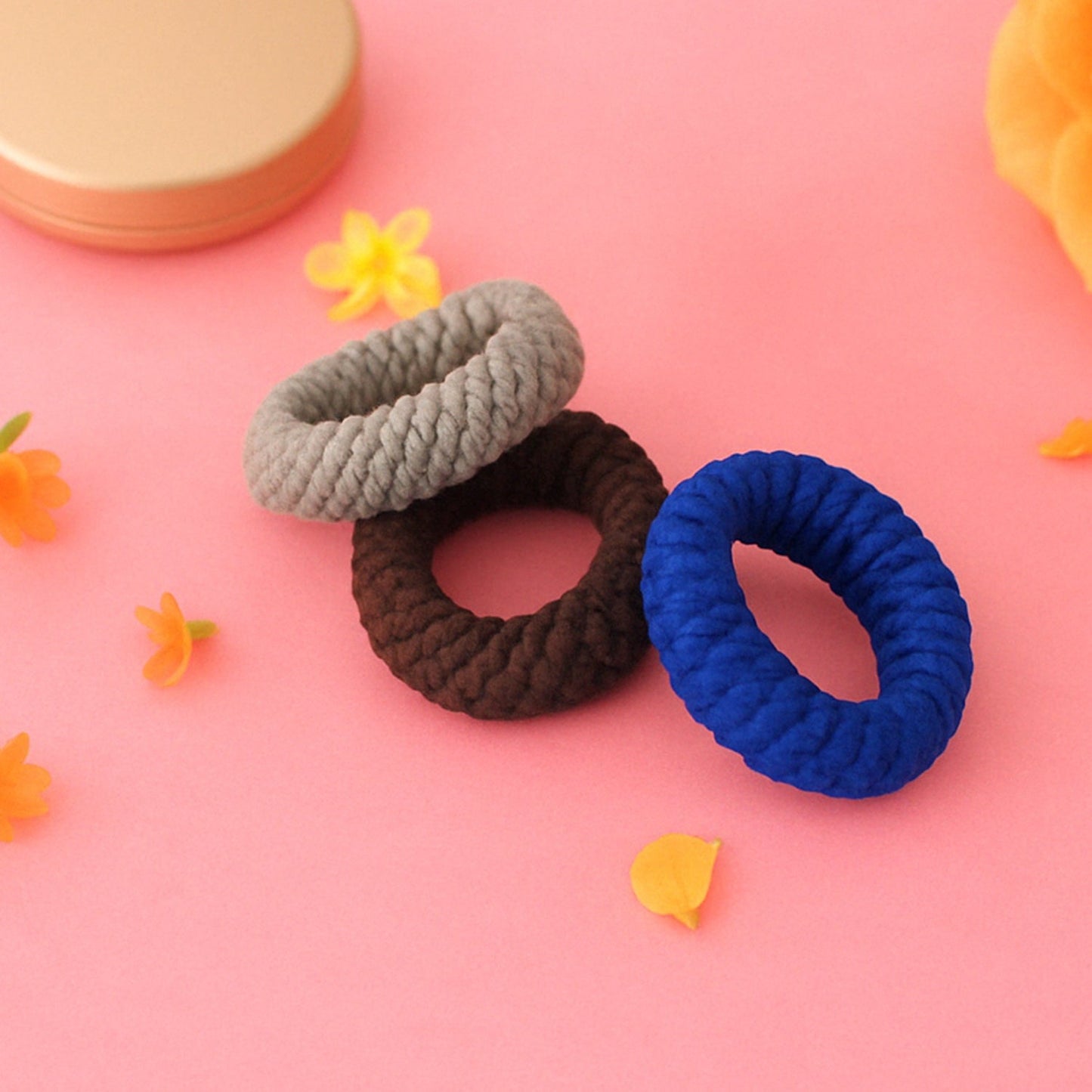 Tyre shape multicolour hair bands in a pack of three, displayed for women.