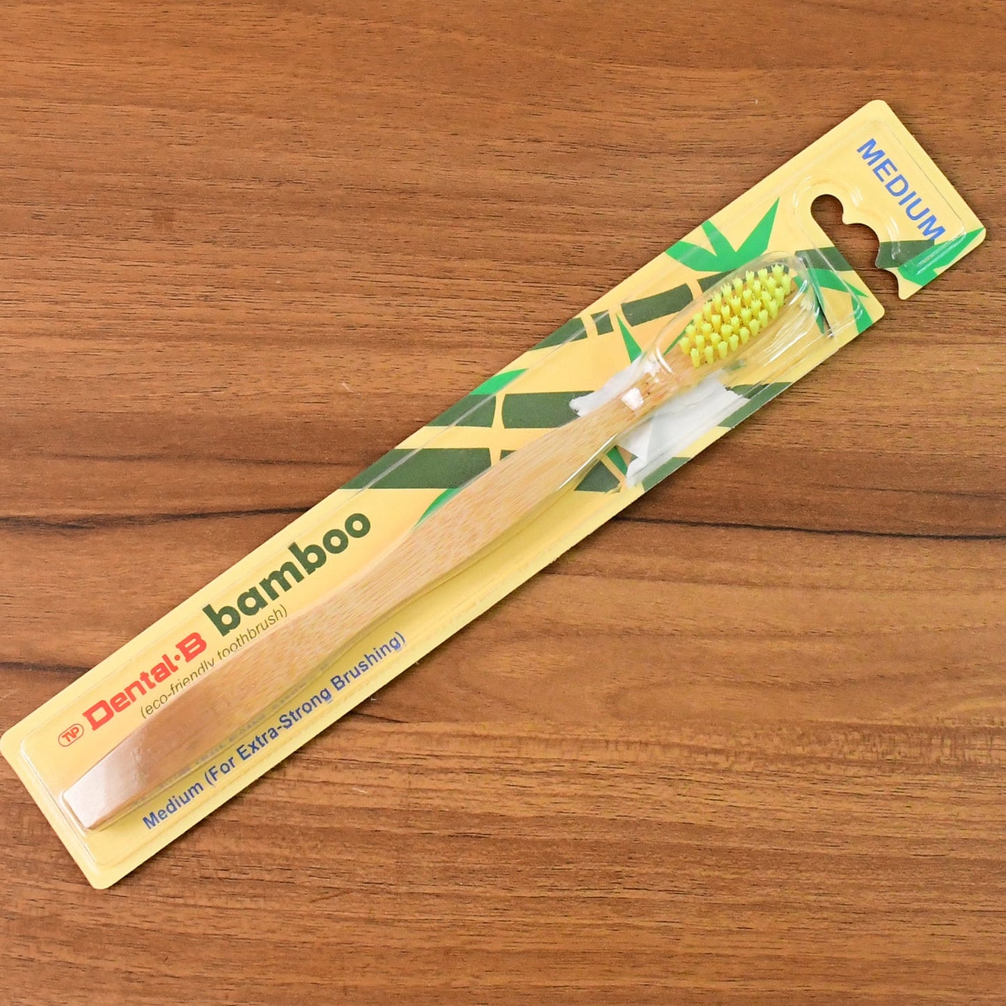 Compostable bamboo toothbrush displayed on white background