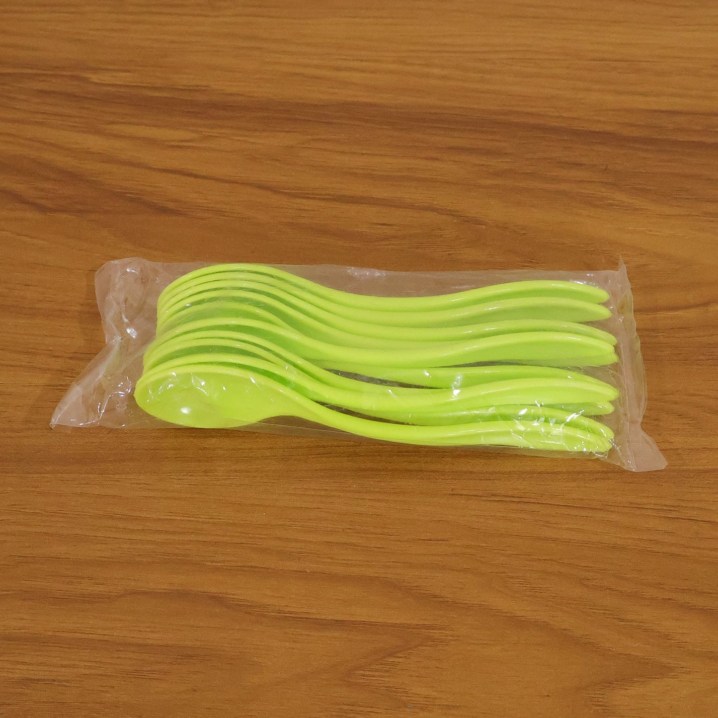 Collection of white plastic spoons arranged neatly, ready for use at any meal.