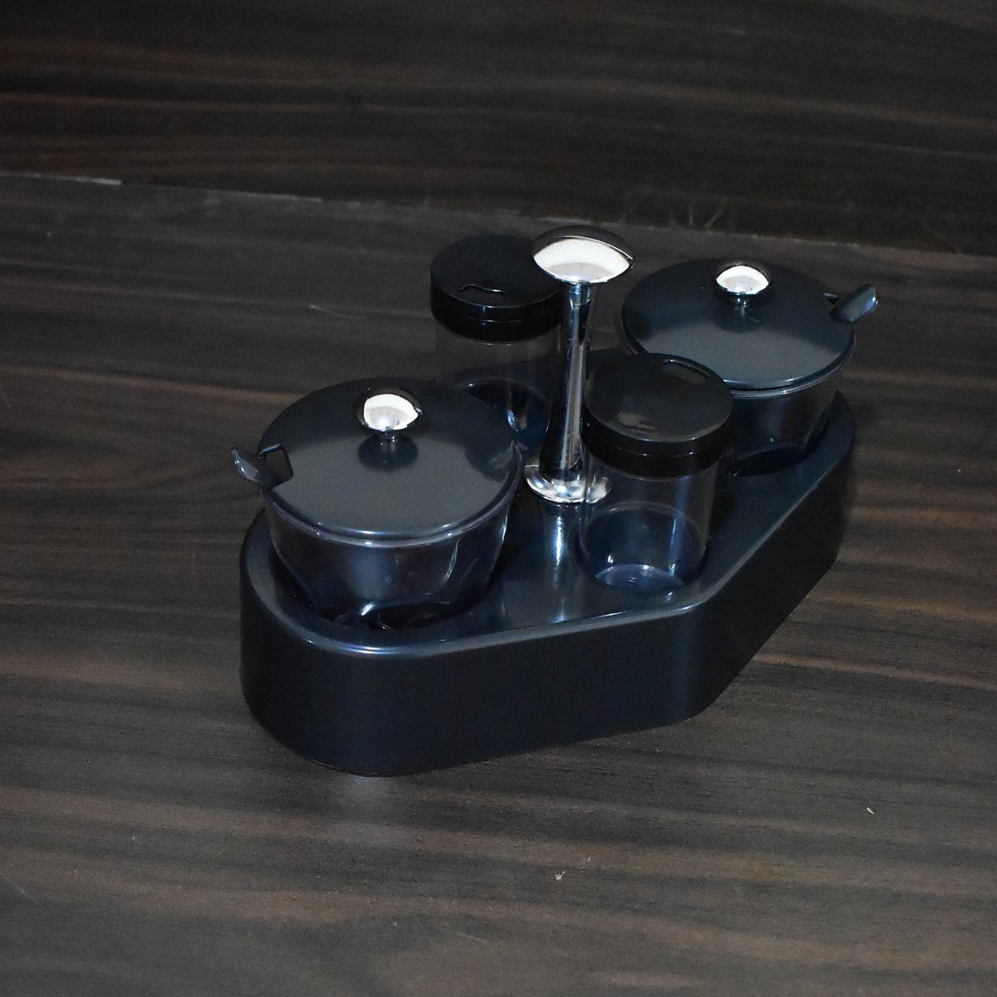 Transparent plastic jar from the Ganesh Spice Condiment Set, ideal for viewing contents.