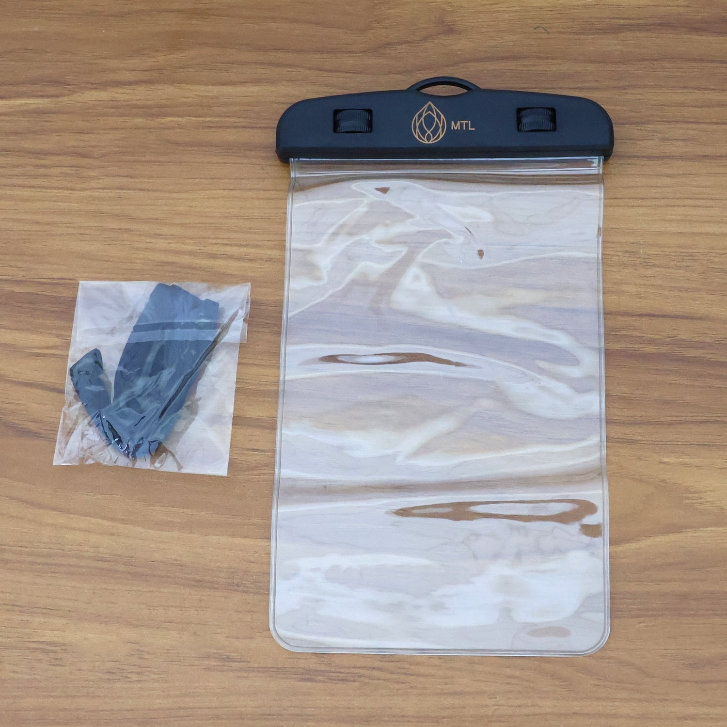 A transparent mobile pouch with a black top and gold