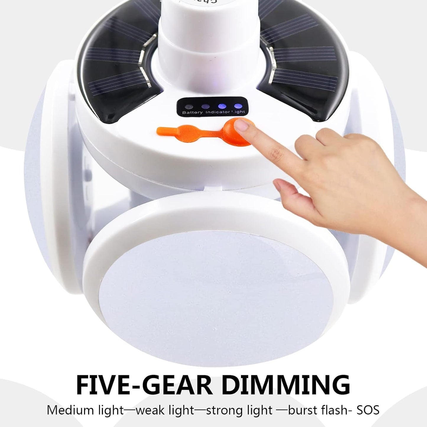 A hand presses the orange button on the white solar camping light, showing the battery indicator lights and the five-gear