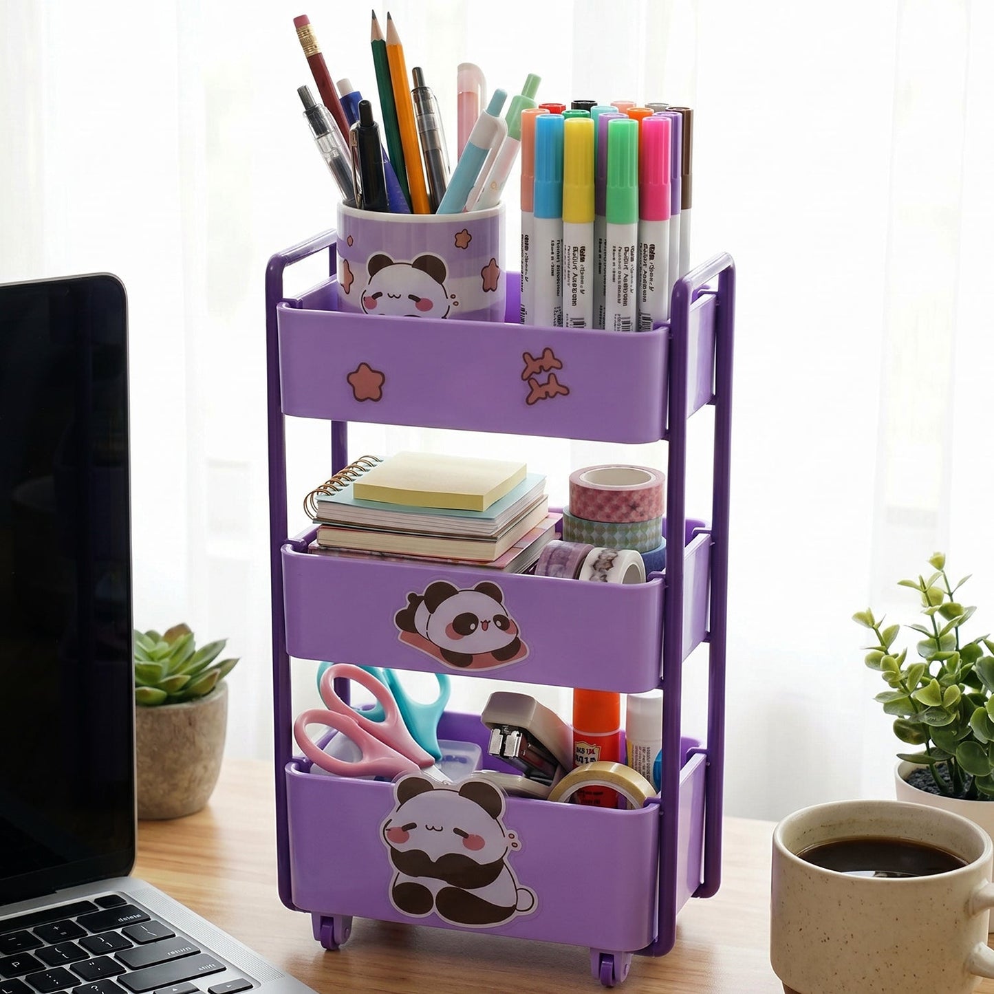 Children's desk with mini storage trolley containing craft supplies.