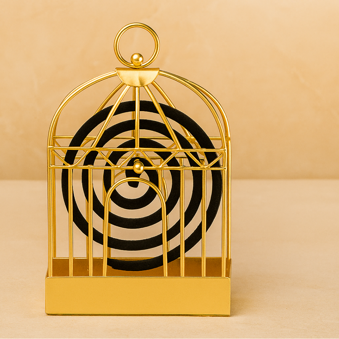 A gold metal birdcage-style holder with a black mosquito coil is centered against a warm beige background.