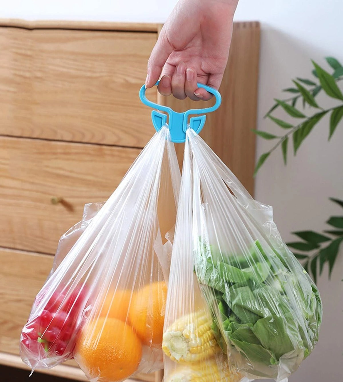 Lifestyle shot of the portable bag holder in use, reducing strain on hands, includes two pieces.