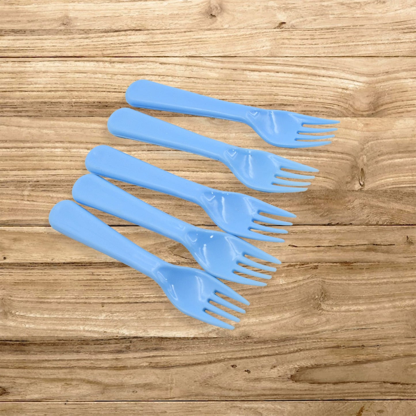 A neatly arranged set of five reusable plastic forks in a clean kitchen setting.