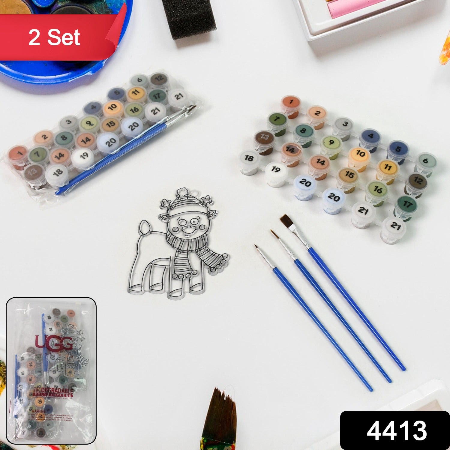 Close-up of the 21 numbered acrylic paint colors and fine brushes included in the art kit.