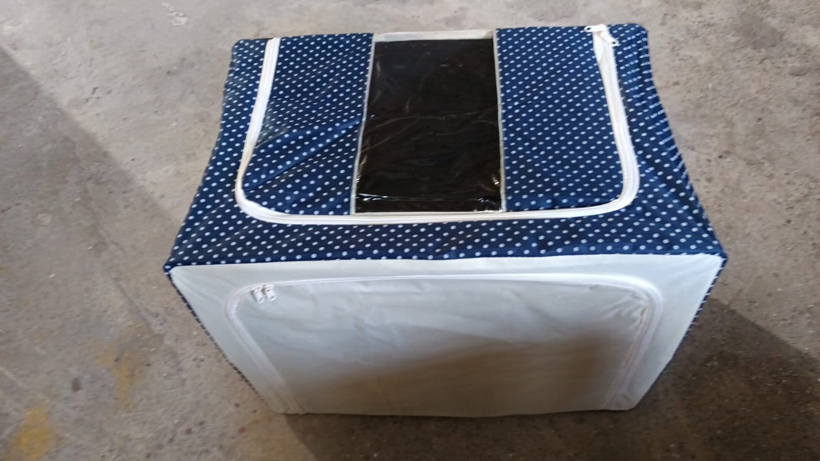 Empty foldable storage bag showcasing its clear window and sturdy design.