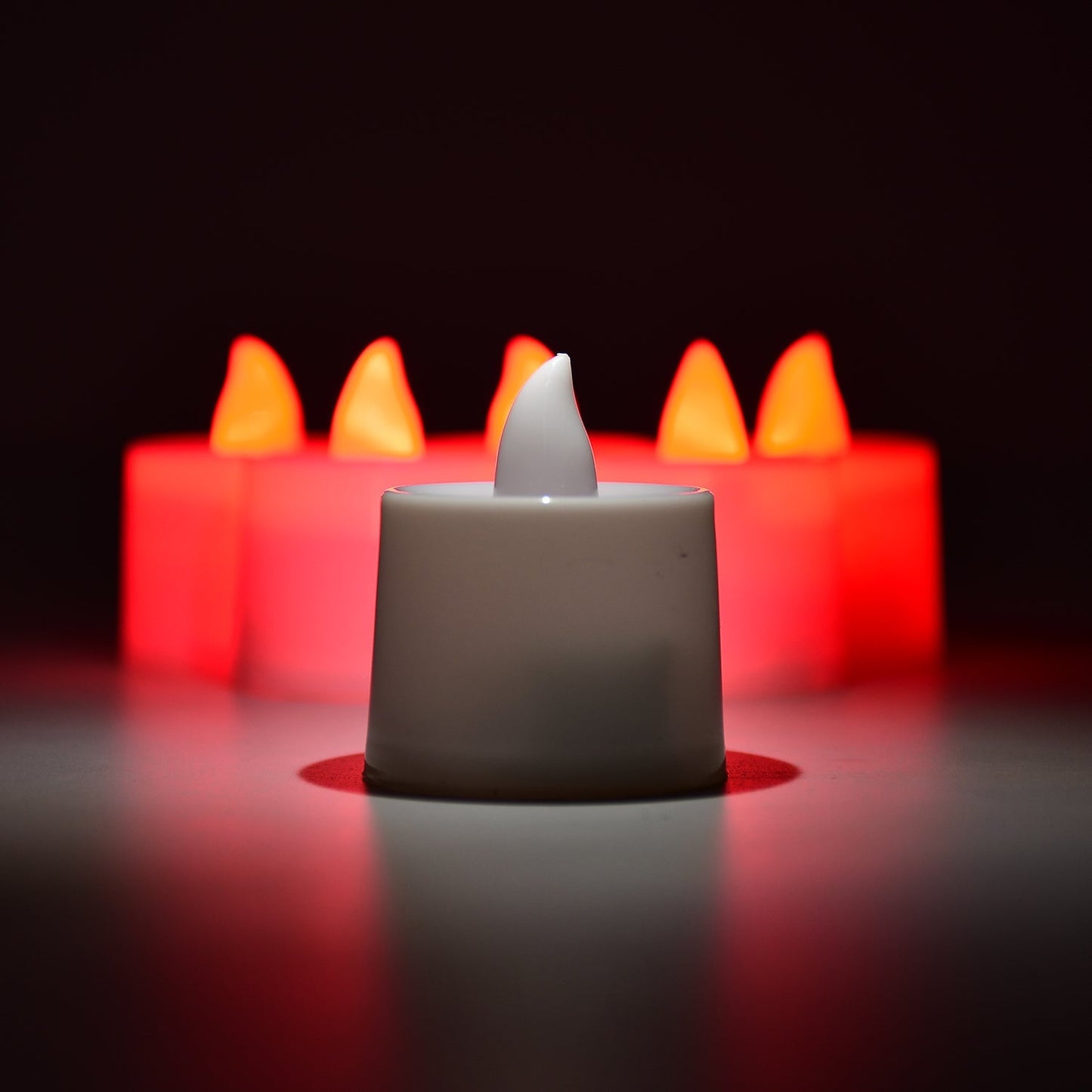 LED tea lights casting a soft red glow, ideal for home decoration.