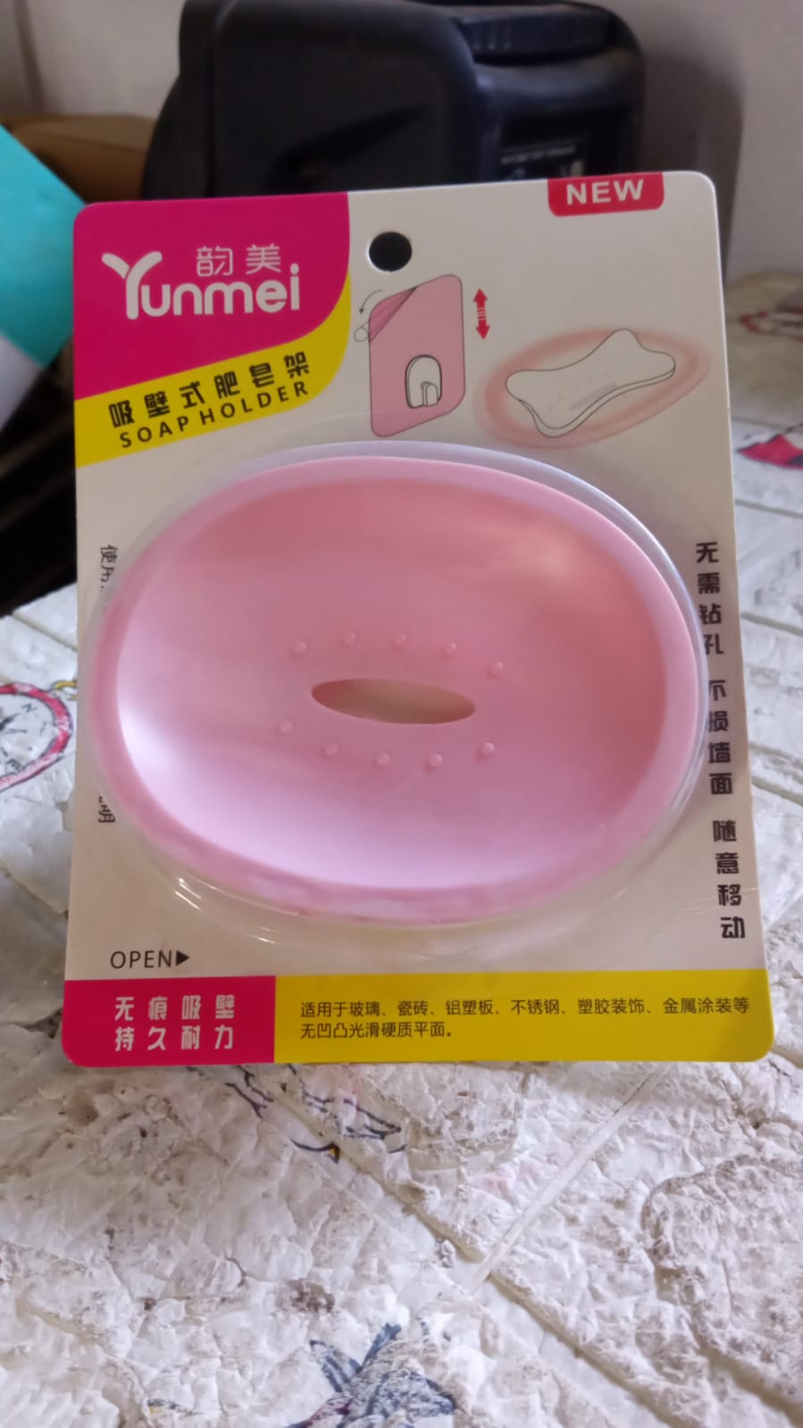 A practical wall mounted soap holder keeping soap dry and accessible in a kitchen sink area.