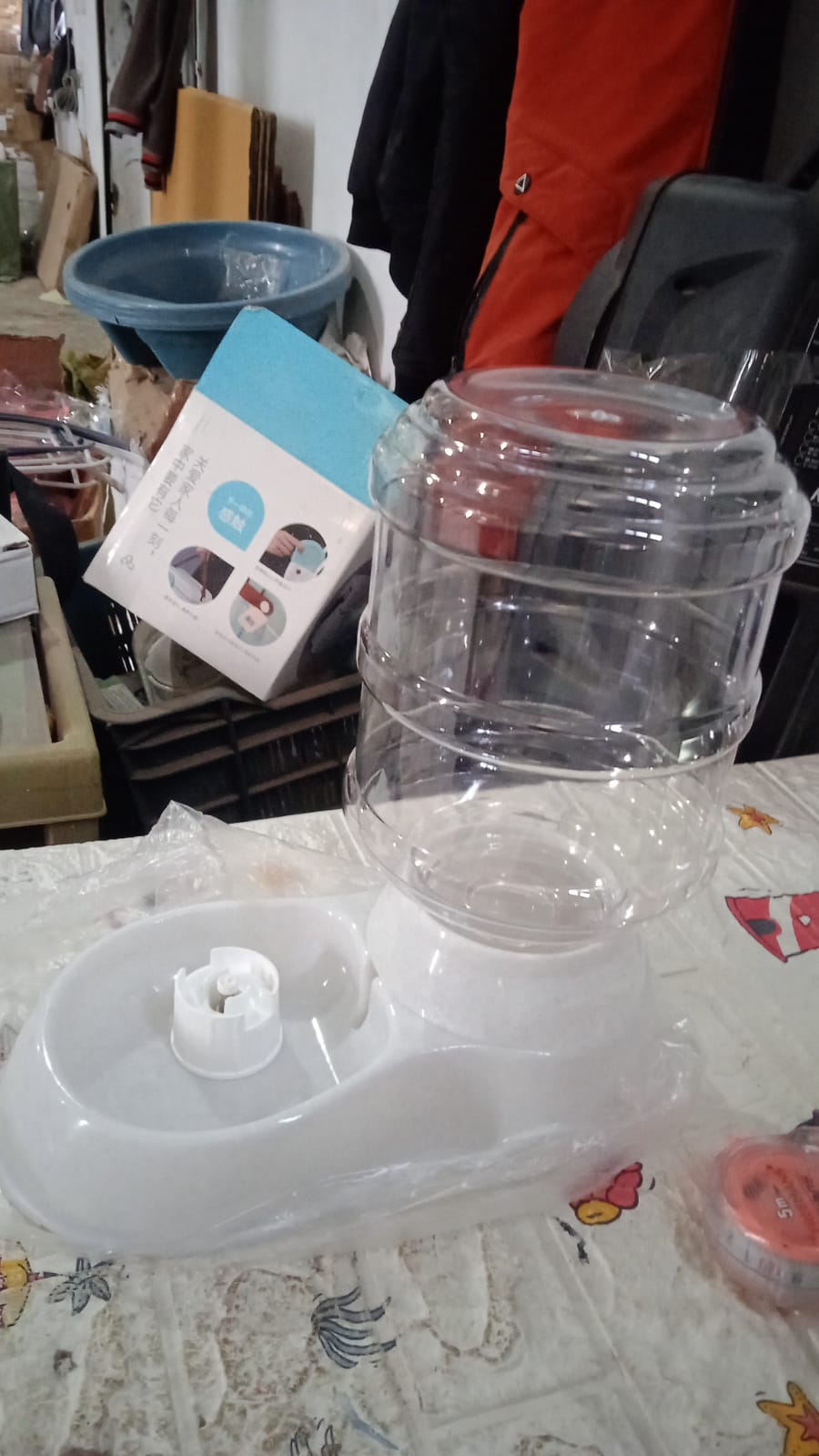 Automatic pet food dispenser with a transparent container for easy monitoring of food levels.