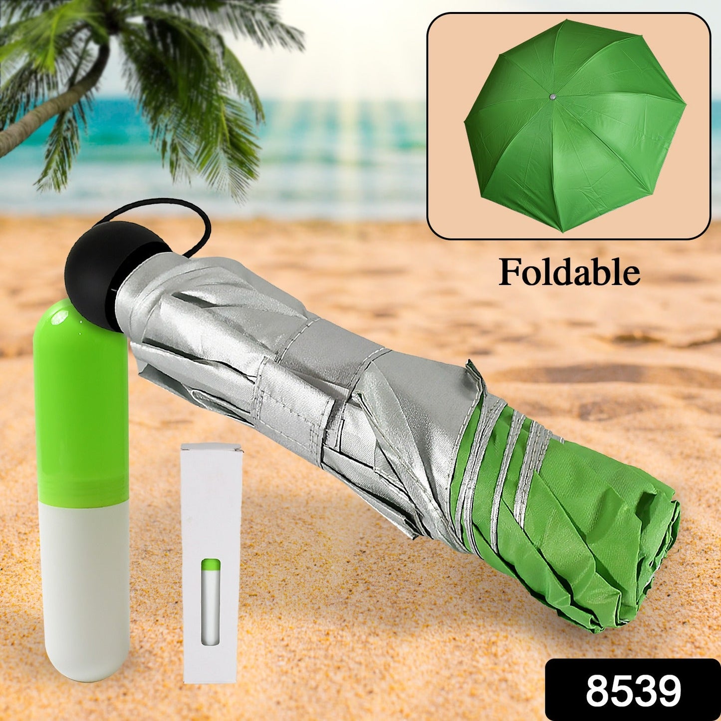 A green and silver umbrella is folded next to its white and green capsule case on a sandy beach, with a small inset of the