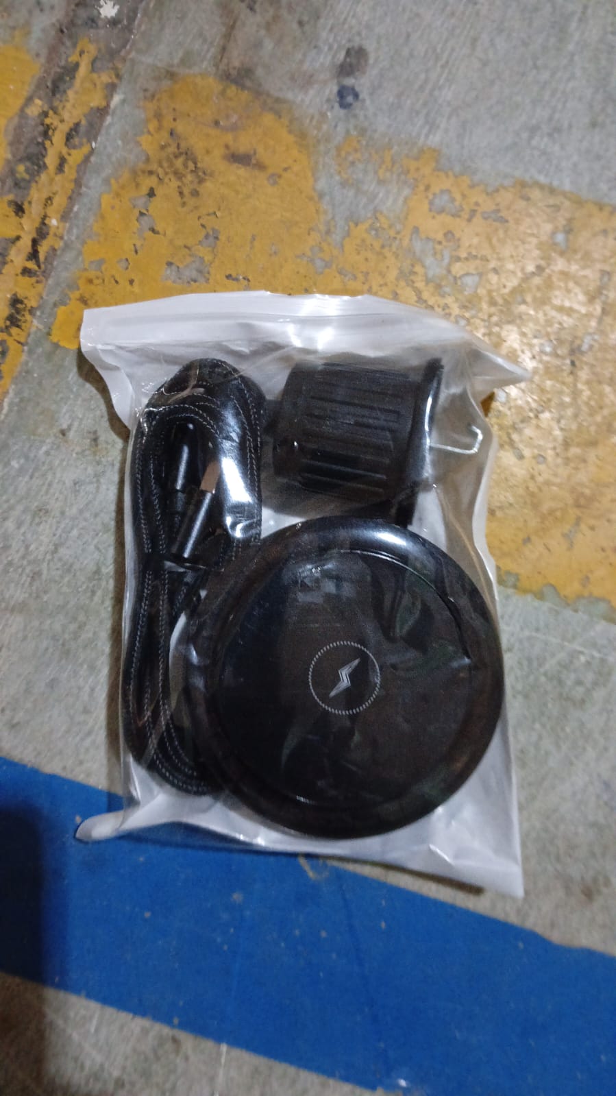 User demonstrating the compact design of the magnetic wireless car charger.