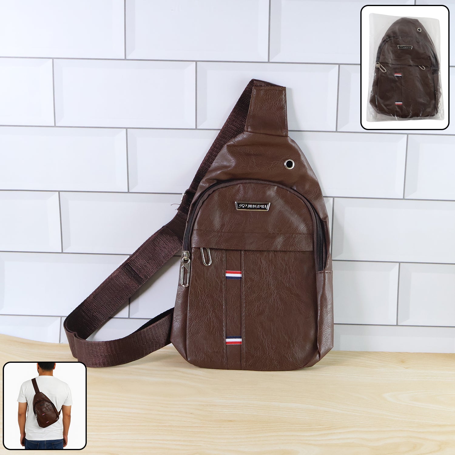 A brown leather crossbody bag with a wide strap, featuring a metal logo and red, white, and blue stripes.
