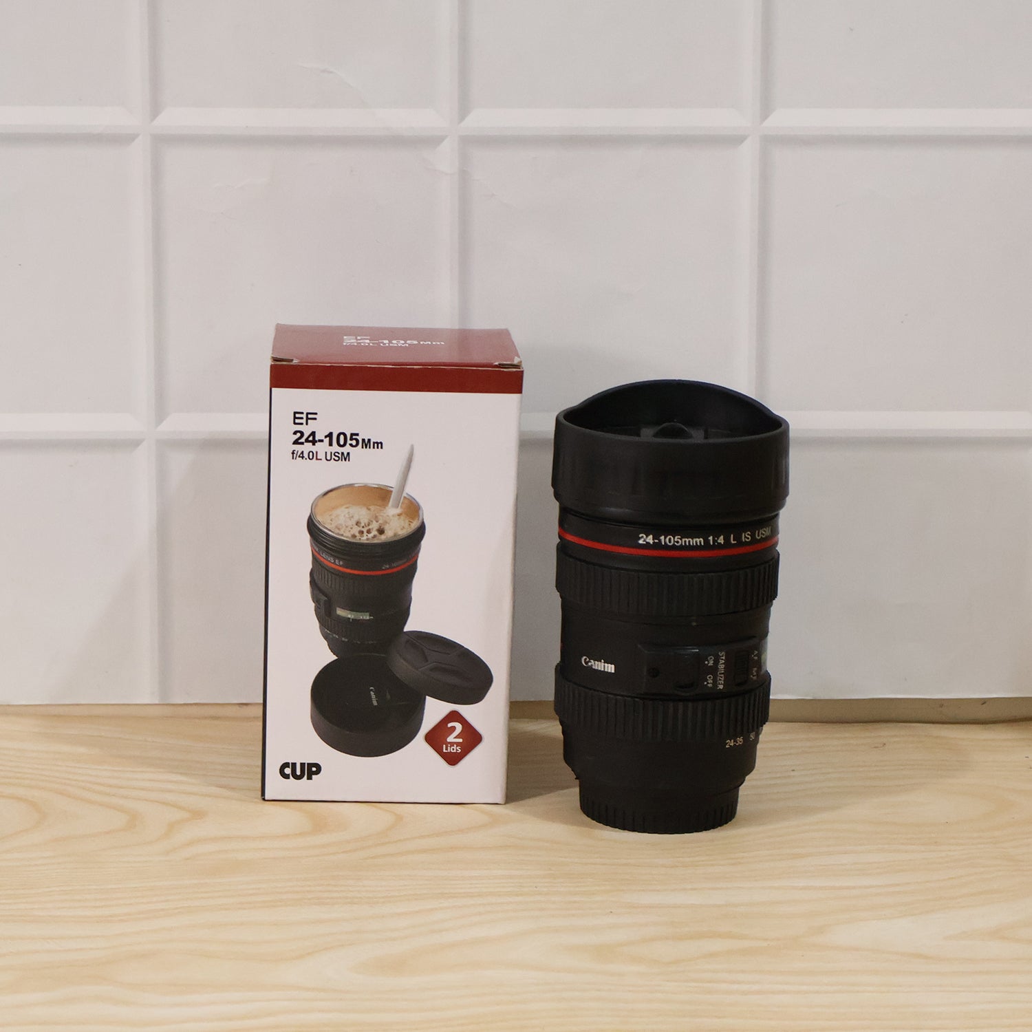Camera lens coffee mug placed on a table with a camera, perfect for photography lovers.