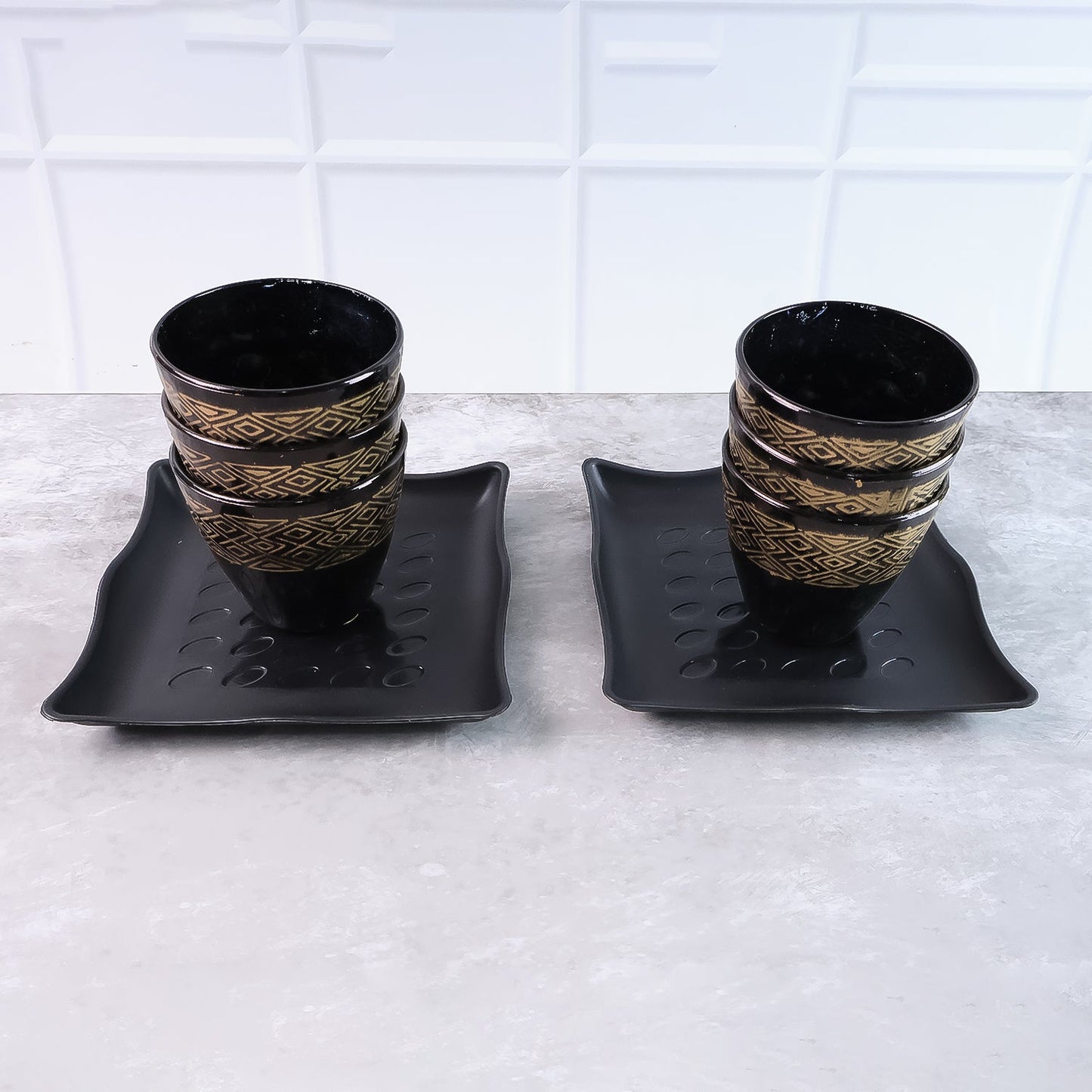 Artfully arranged ceramic dining set with six cups and two bowls, ready for use.