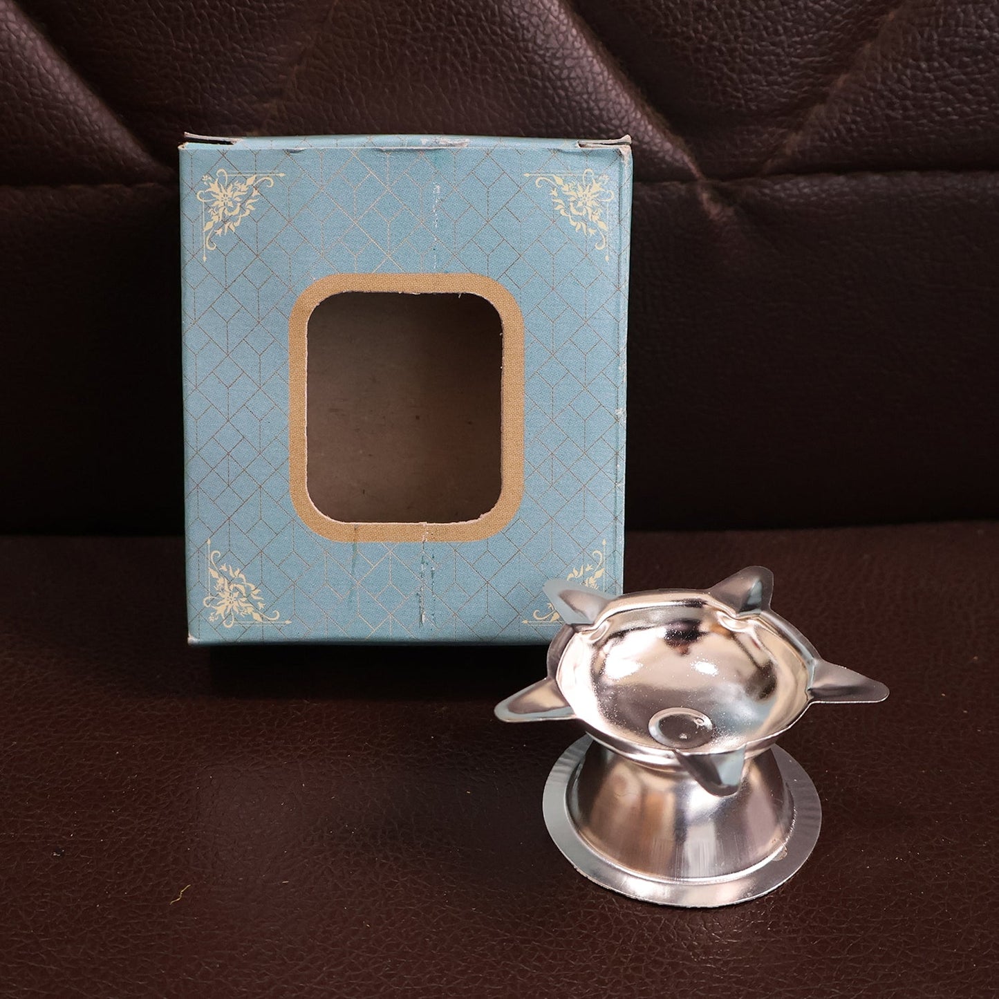 Stainless steel lotus design diya used in home temples for prayer lighting