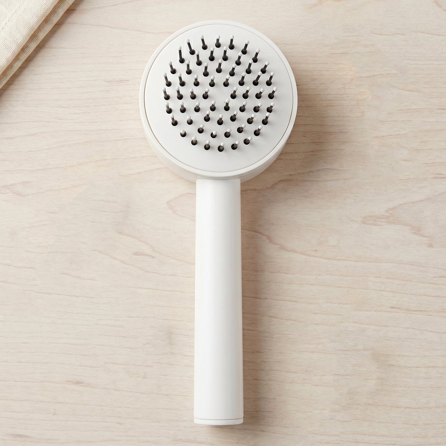 Person using the detangling air cushion brush for smooth, knot-free hair.