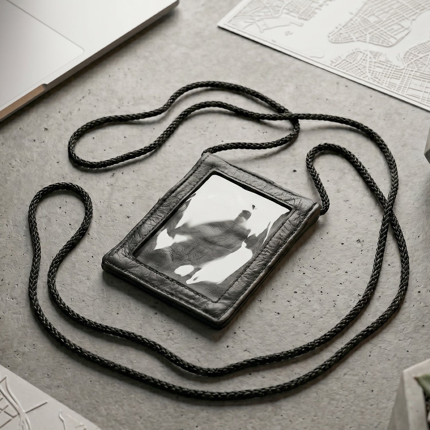 Close-up of the black PU leather neck wallet showing the clear ID window
