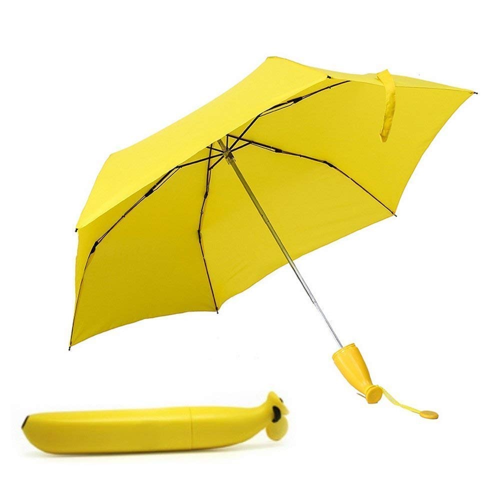 An open yellow umbrella with a banana-shaped handle stands next to its closed banana-shaped case on a white background.