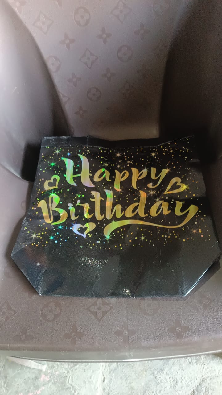 Additional angle showing reusable black and gold birthday gift bag